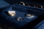 Gold ring with a pear-shaped lab-grown diamond surrounded by a halo of round stones