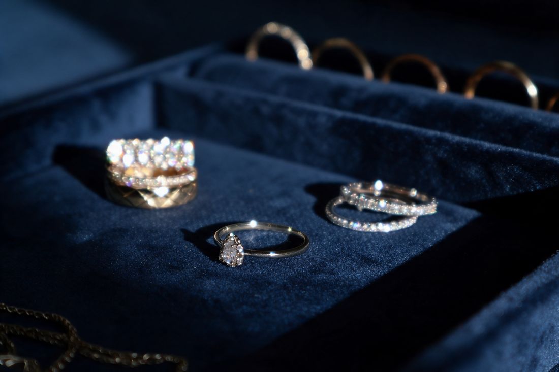 Gold ring with a pear-shaped lab-grown diamond surrounded by a halo of round stones