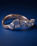 Gold ring set with five lab-grown diamonds in five different cuts along the band