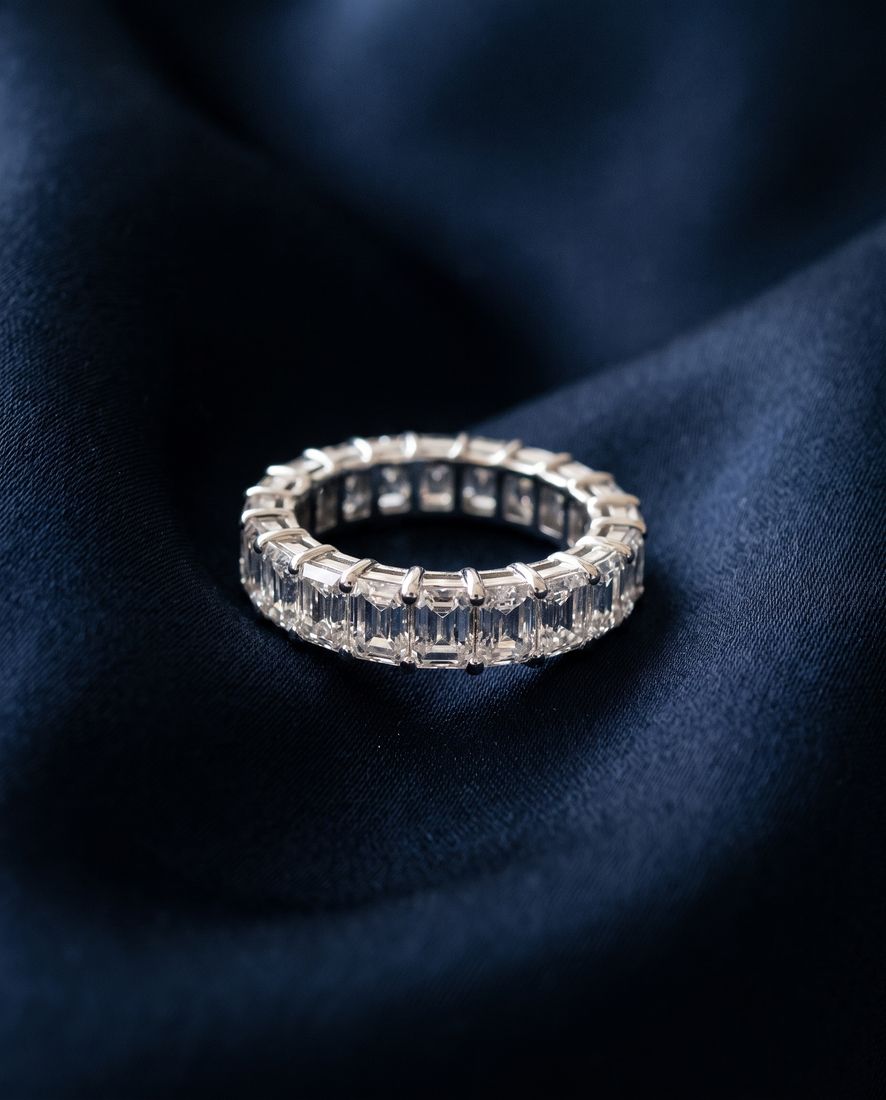 Gold eternity band set all the way around with rectangular emerald-cut lab-grown diamonds