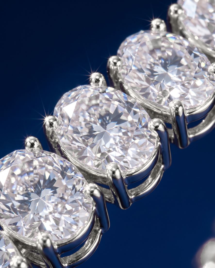 Tennis bracelet of oval-cut lab-grown diamonds set side by side in gold