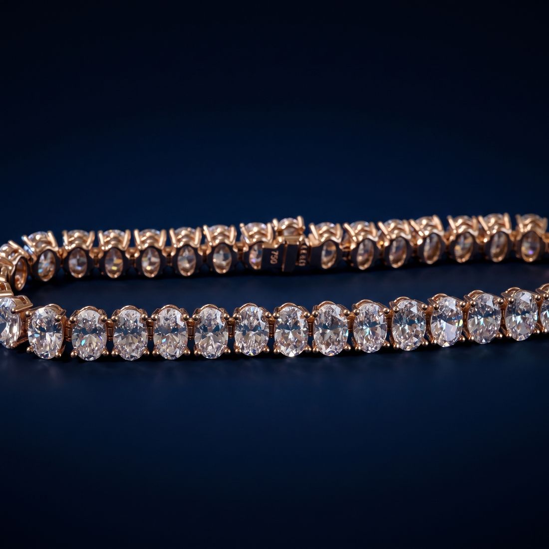 Tennis bracelet of oval-cut lab-grown diamonds set side by side in gold