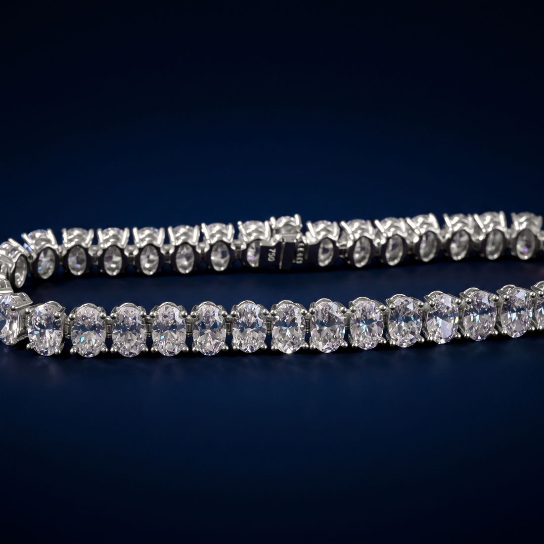 Tennis bracelet of oval-cut lab-grown diamonds set side by side in gold