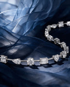 Gold bracelet with sixteen individually set lab-grown diamonds in mixed cuts joined by short polished bars