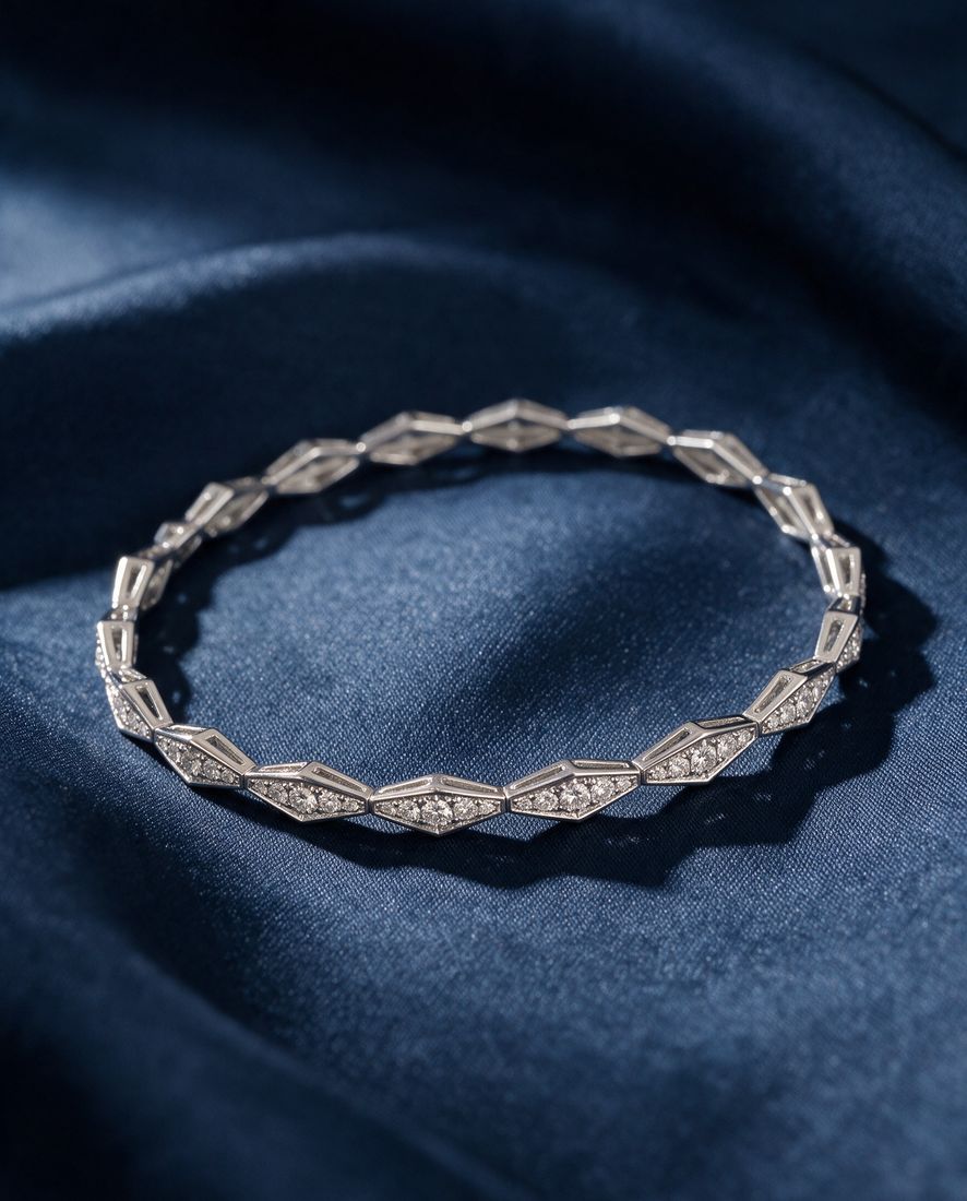 Solid gold bracelet of faceted rhombus links pavé-set with small round lab-grown diamonds, shown on a plain ground