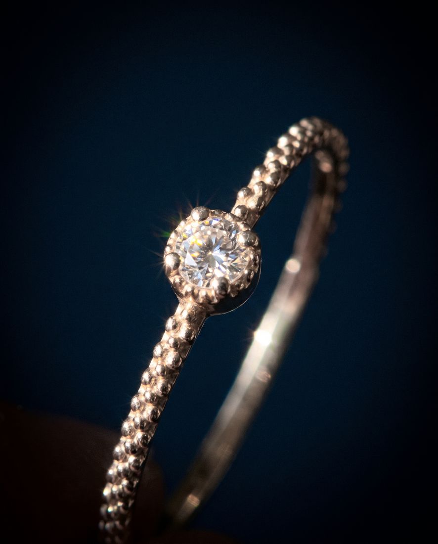Thin twisted gold band set with a single cognac lab-grown diamond