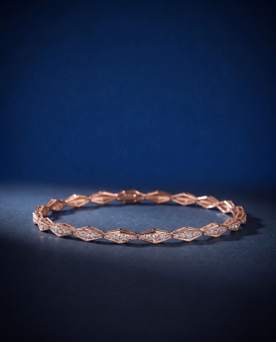 Solid gold bracelet of faceted rhombus links pavé-set with small round lab-grown diamonds, shown on a plain ground