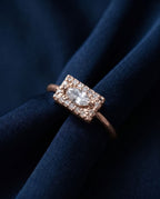 Gold ring with a flat rectangular panel set with a marquise lab-grown diamond and pavé stones