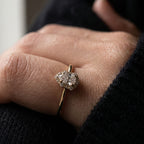 Gold ring with a pear-shaped lab-grown diamond surrounded by a halo of round stones
