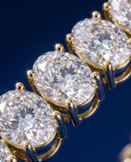 Tennis bracelet of oval-cut lab-grown diamonds set side by side in gold