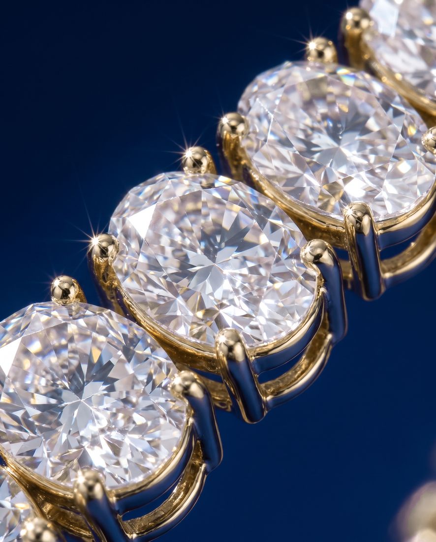 Tennis bracelet of oval-cut lab-grown diamonds set side by side in gold