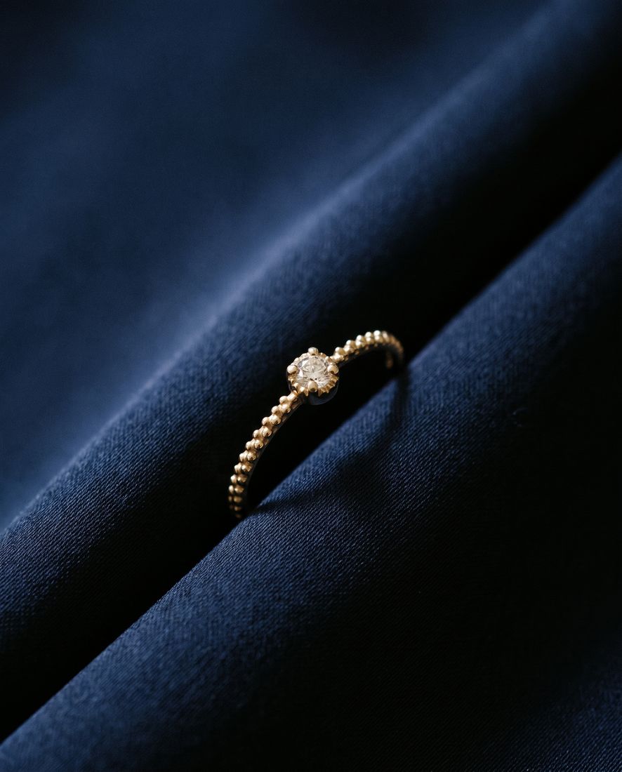 Thin twisted gold band set with a single cognac lab-grown diamond