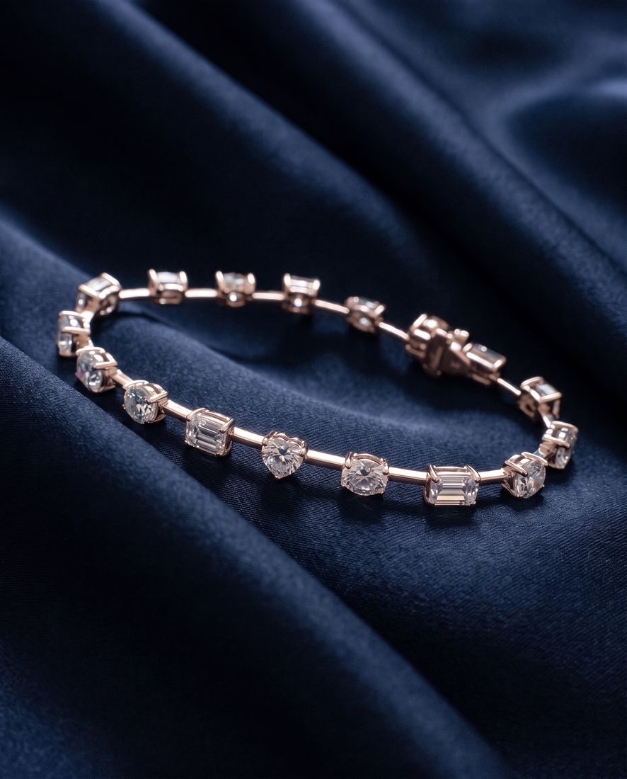 Gold bracelet with sixteen individually set lab-grown diamonds in mixed cuts joined by short polished bars