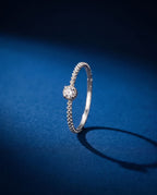 Thin twisted gold band set with a single cognac lab-grown diamond