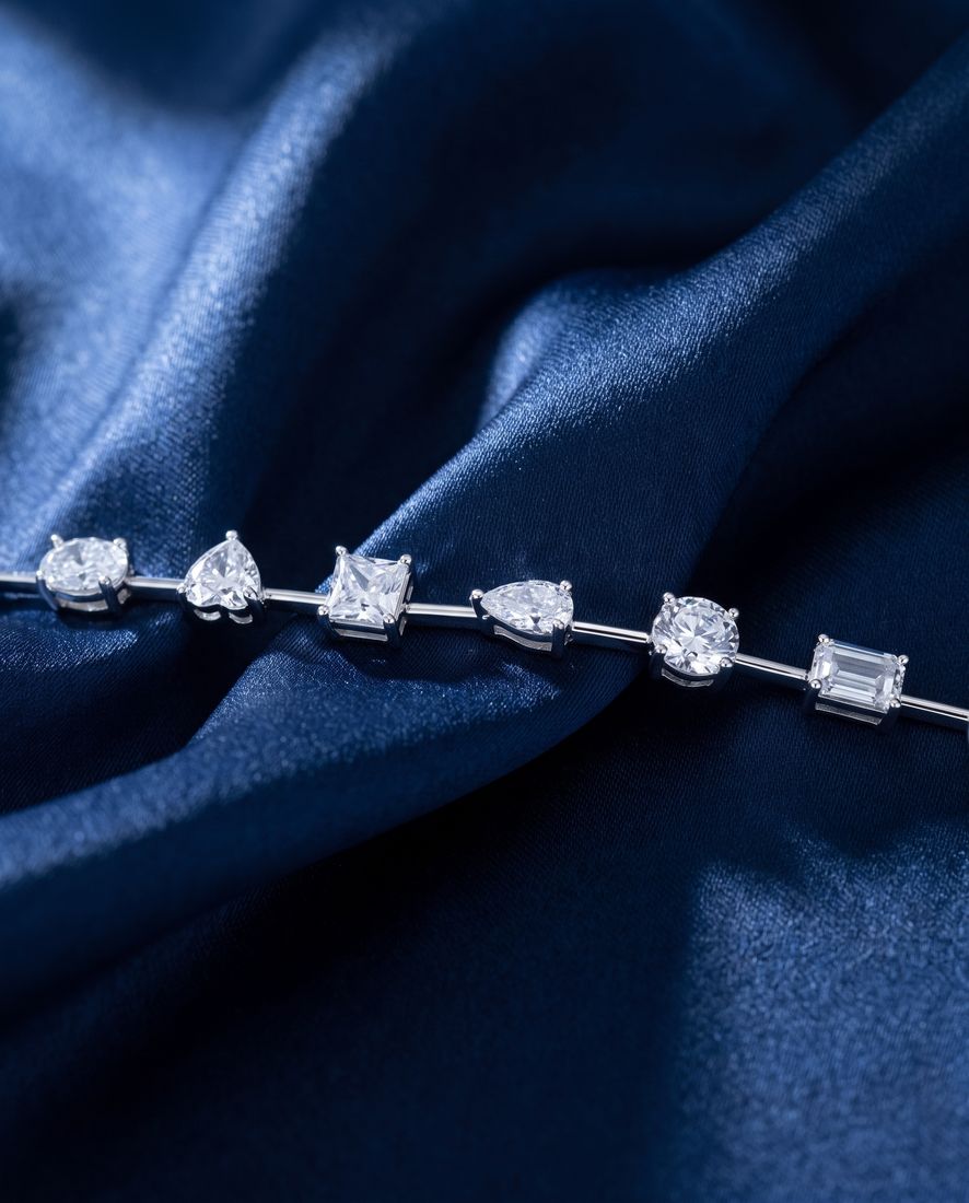 Gold bracelet with sixteen individually set lab-grown diamonds in mixed cuts joined by short polished bars
