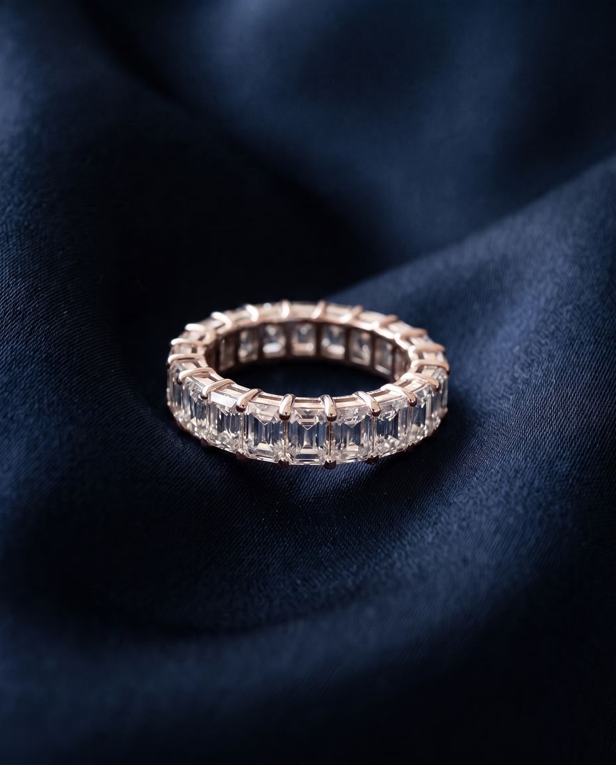 Gold eternity band set all the way around with rectangular emerald-cut lab-grown diamonds