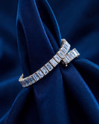 Tennis bracelet of rectangular baguette-cut lab-grown diamonds set end to end in gold