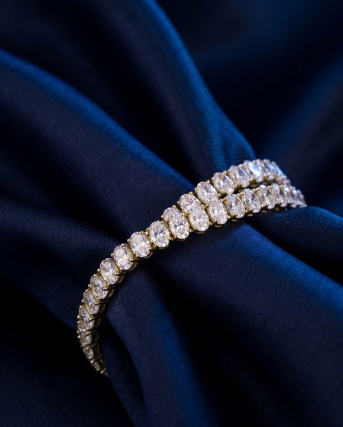 Tennis bracelet of oval-cut lab-grown diamonds set side by side in gold