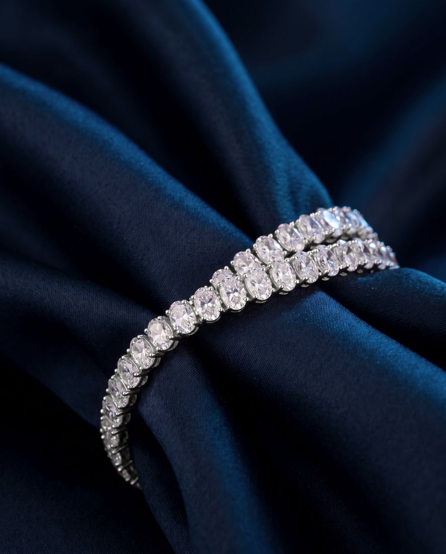 Tennis bracelet of oval-cut lab-grown diamonds set side by side in gold