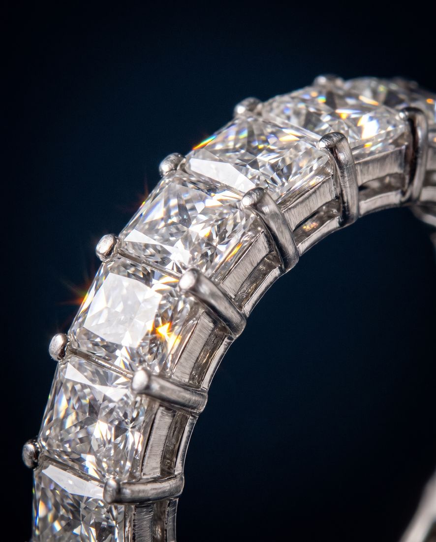 Gold eternity band set all the way around with rectangular emerald-cut lab-grown diamonds