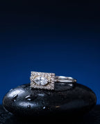 Gold ring with a flat rectangular panel set with a marquise lab-grown diamond and pavé stones