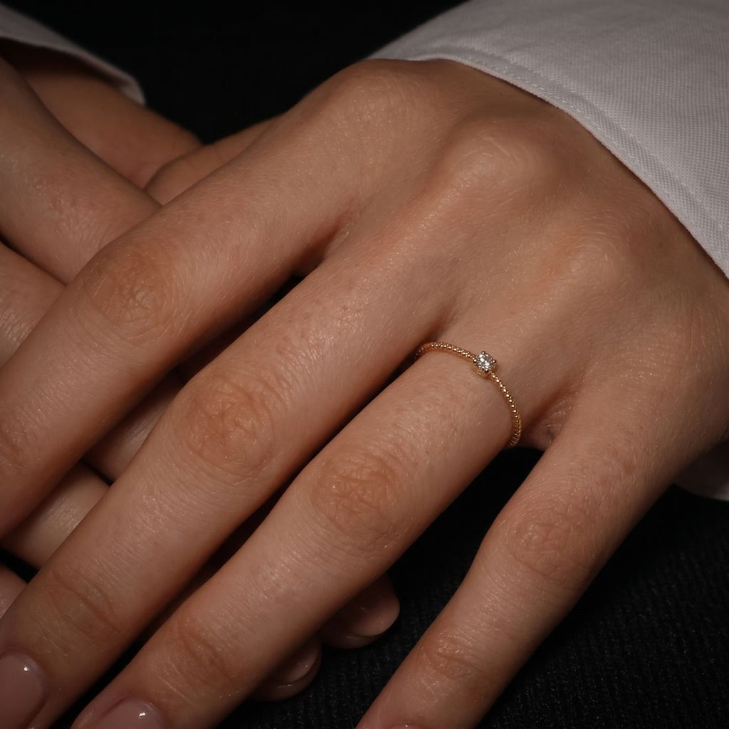 Thin twisted gold band set with a single cognac lab-grown diamond