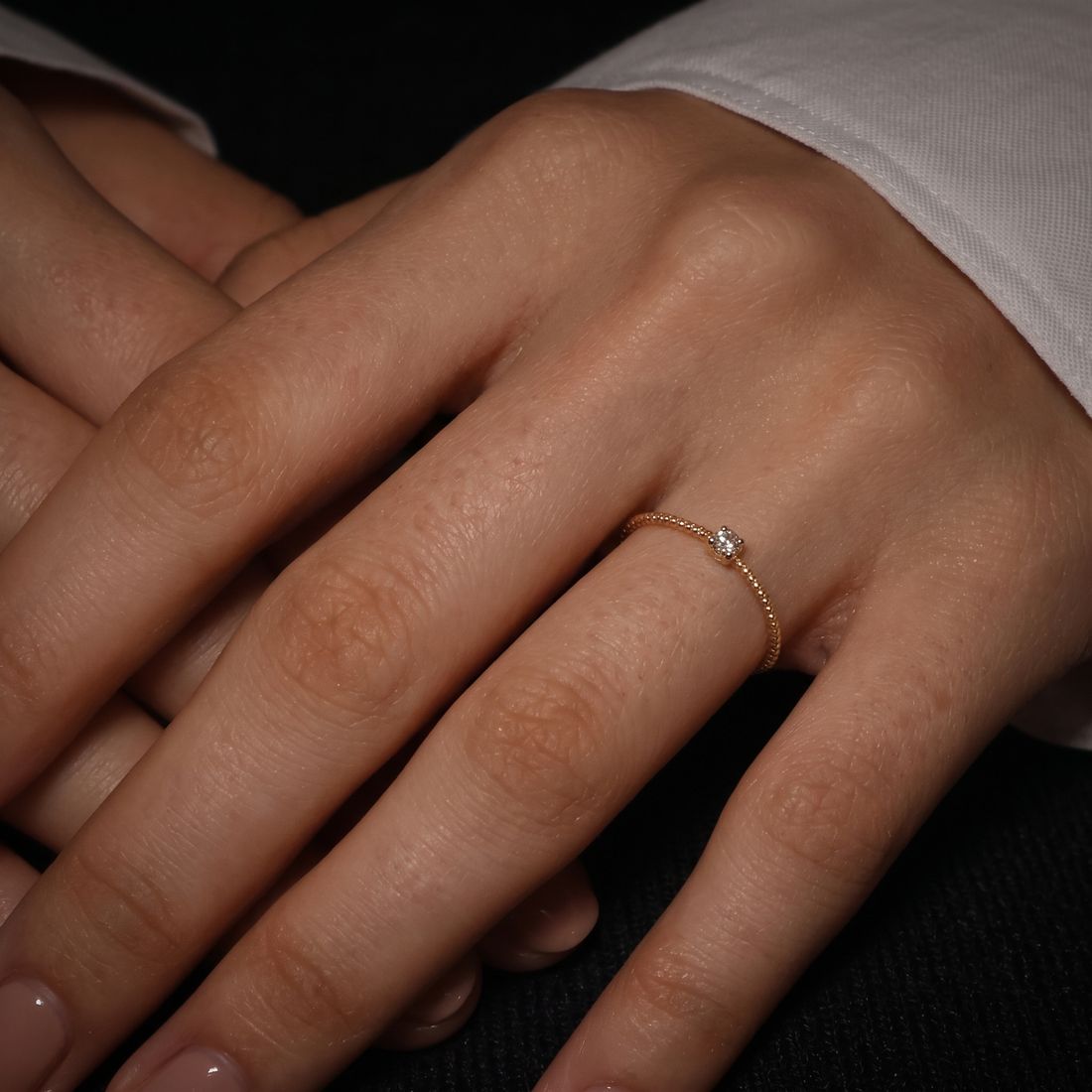 Thin twisted gold band set with a single cognac lab-grown diamond