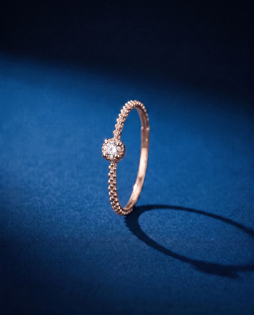 Thin twisted gold band set with a single cognac lab-grown diamond