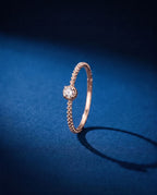Thin twisted gold band set with a single cognac lab-grown diamond