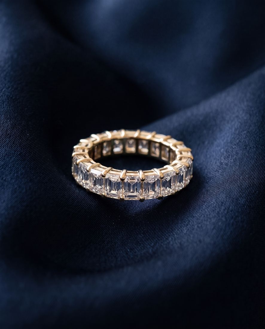 Gold eternity band set all the way around with rectangular emerald-cut lab-grown diamonds