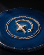 Fine gold chain with a slender pendant set with a marquise lab-grown diamond and small round stones