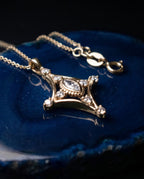 Fine gold chain with a slender pendant set with a marquise lab-grown diamond and small round stones